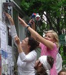 artists stretching while putting up posters